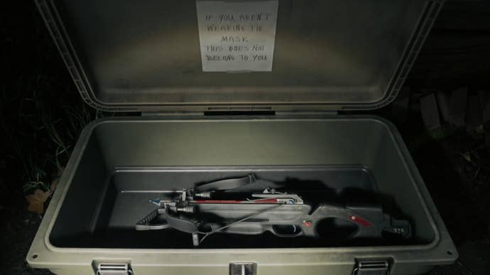 first person view of an open cult stash container with a crossbow weapon inside