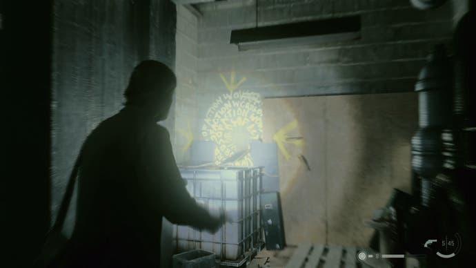 alan shining his flashlight on a word of power on a wall beside wooden materials and a white crate