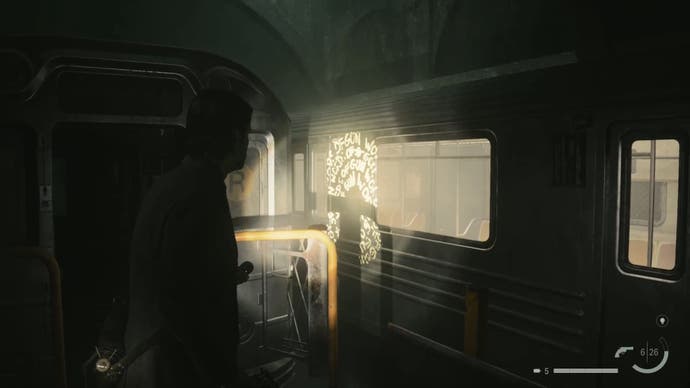 alan shining his flashlight on a word of power printed on a subway car in an abandoned subway station