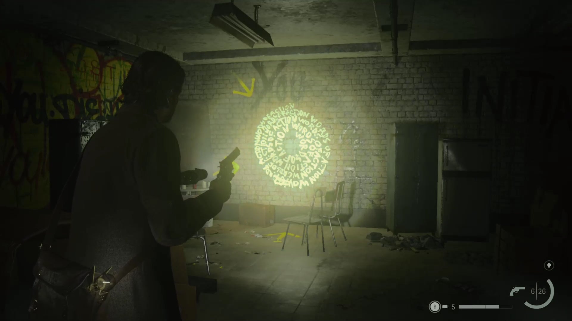 alan shining his flashlight on a word of power on a wall in an abandoned subway station