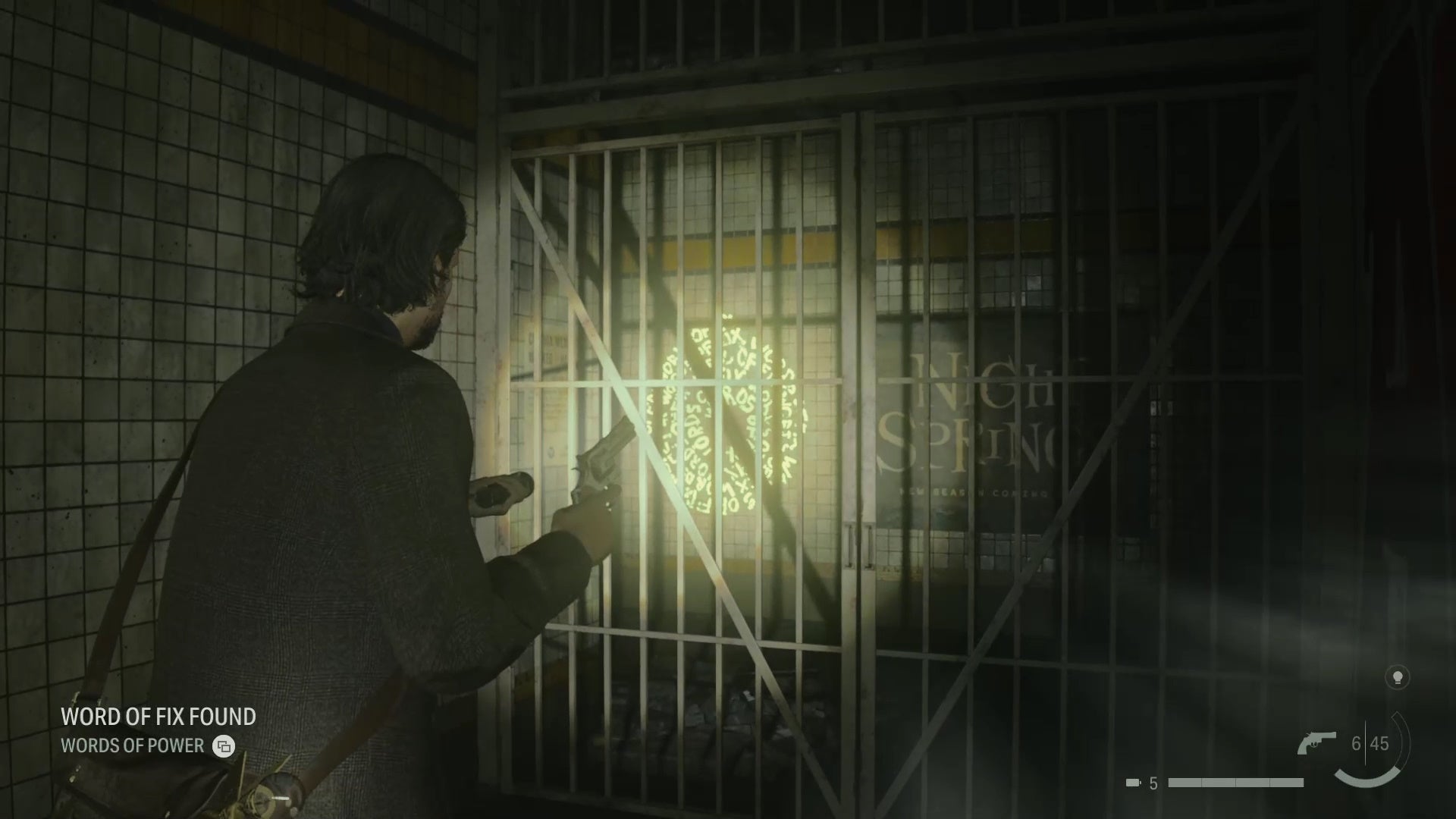 alan shining his flashlight on a word of power on a wall behind a barred door in an abandoned subway station