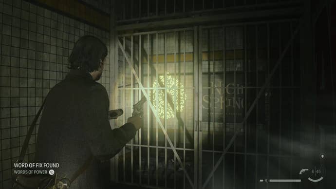 alan shining his flashlight on a word of power on a wall behind a barred door in an abandoned subway station