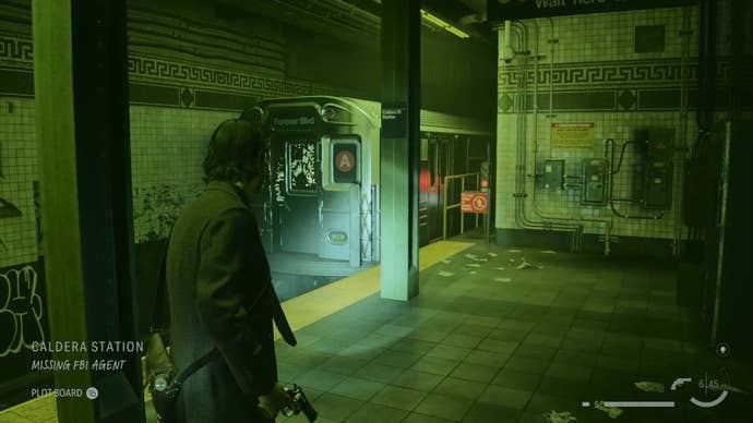 alan shining his flashlight on a word of power on a subway car in an abandoned subway station