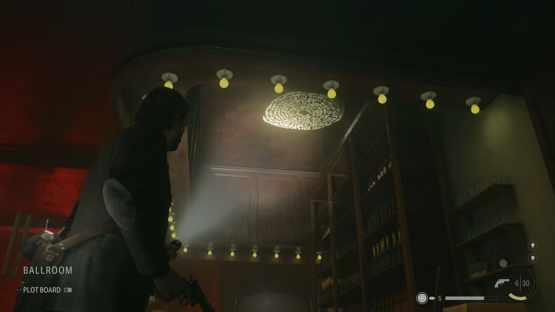 alan shining his flashlight on a word of power on the ceiling of a bar in an abandoned hotel