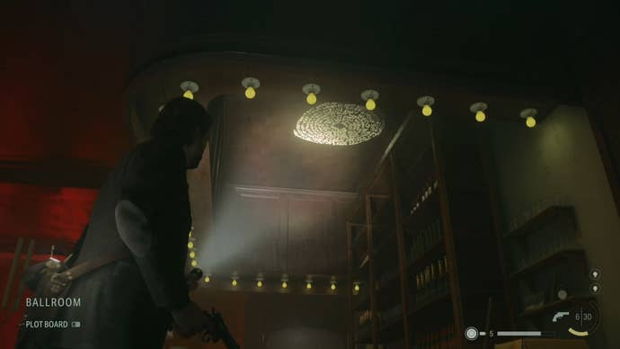 alan shining his flashlight on a word of power on the ceiling of a bar in an abandoned hotel