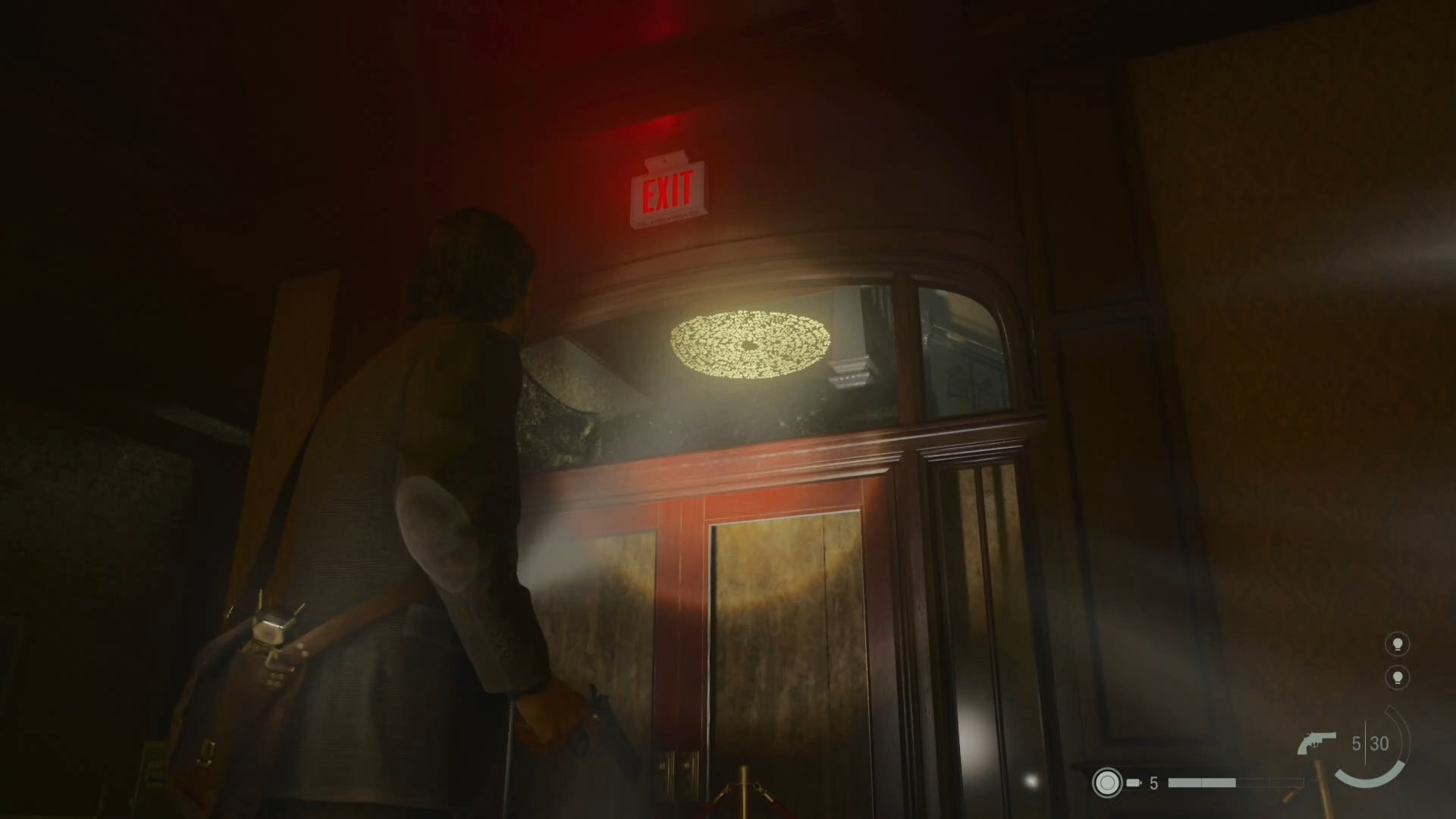 alan shining his flashlight on a word of power on the underside of a set of stairs while looking through a gap above a wooden door in an abandoned hotel