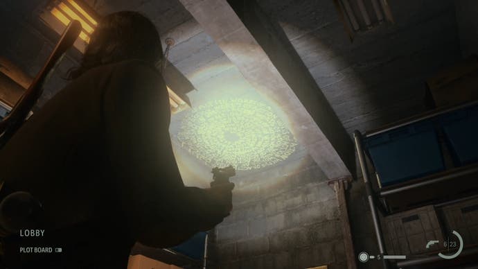 alan shining his flashlight on a word of power on the ceiling of a narrow corridor in a rundown cinema