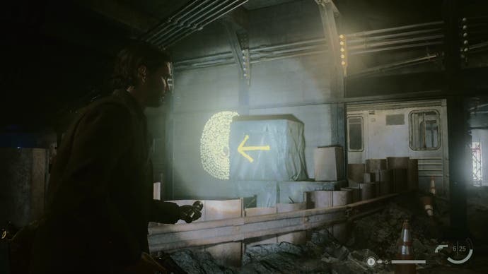 alan shining his flashlight on a word of power on a wall in an abandoned subway station, with a yellow arrow pointing to the word