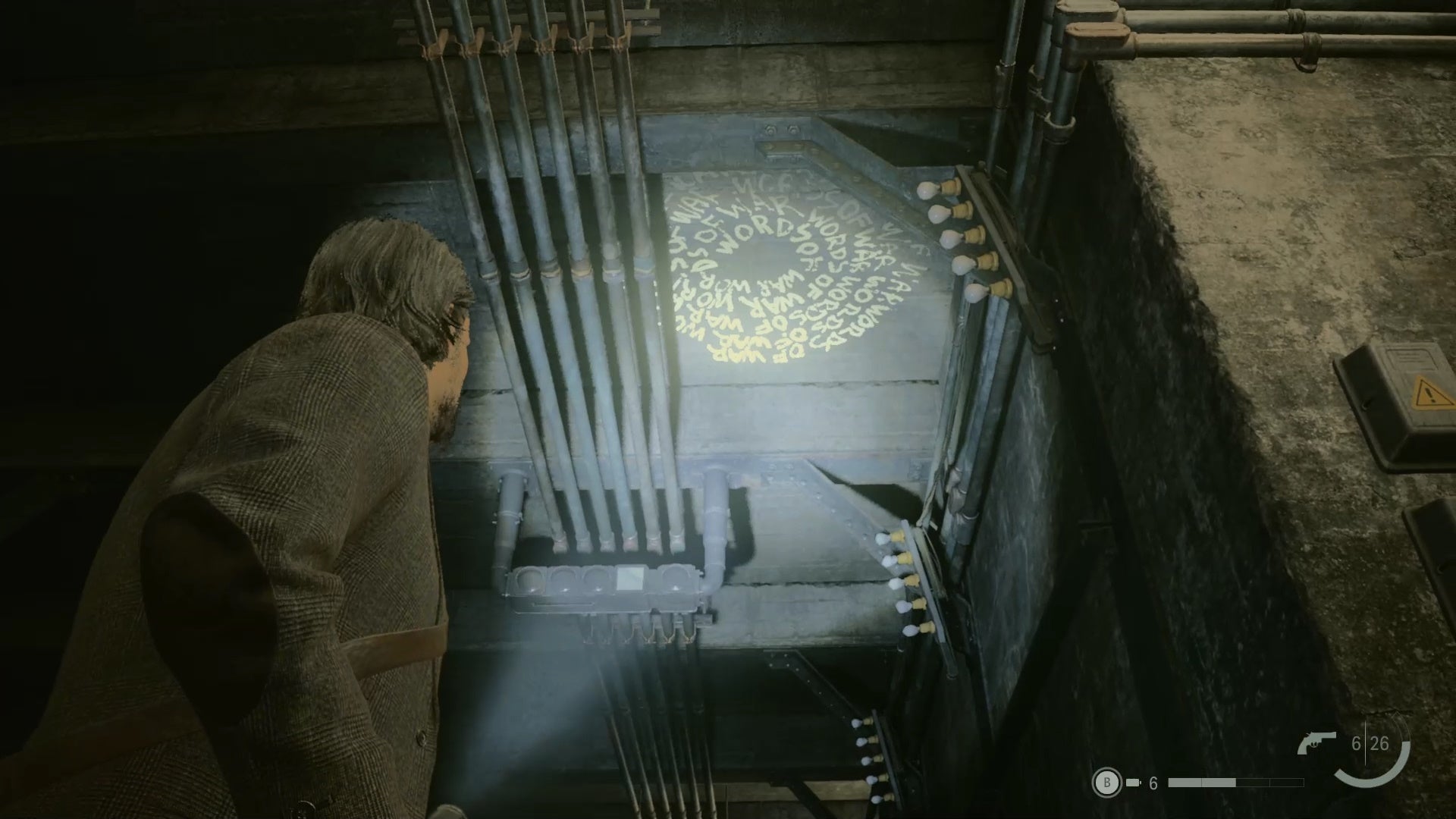 alan shining his flashlight on a word of power on the ceiling of an abandoned subway station