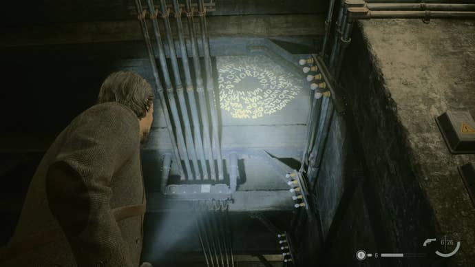 alan shining his flashlight on a word of power on the ceiling of an abandoned subway station