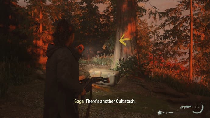 saga shining her flashlight on a cult stash by a tree in the woods with a yellow arrow pointing left on the tree