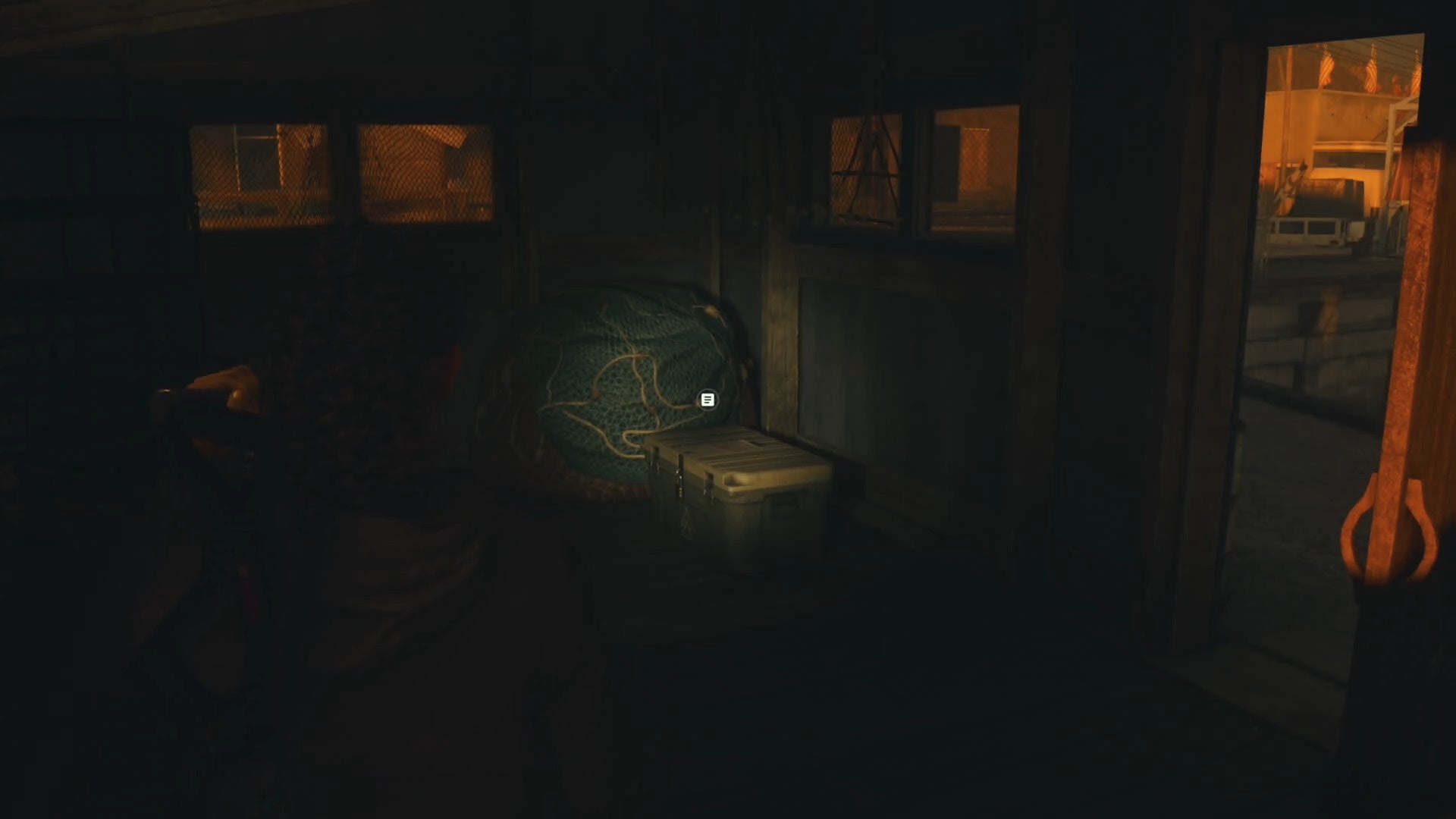 saga shining her flashlight on a cult stash inside a messy shack with fishing gear