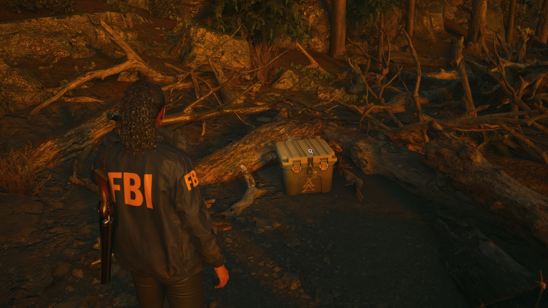 saga shining her flashlight on a cult stash on a beach covered in downed trees