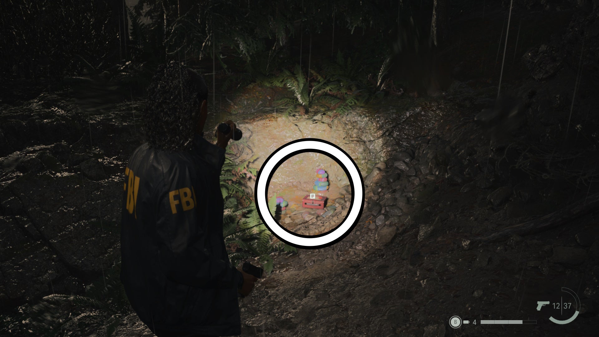 saga shining her flashlight on a lunch box on a forest floor