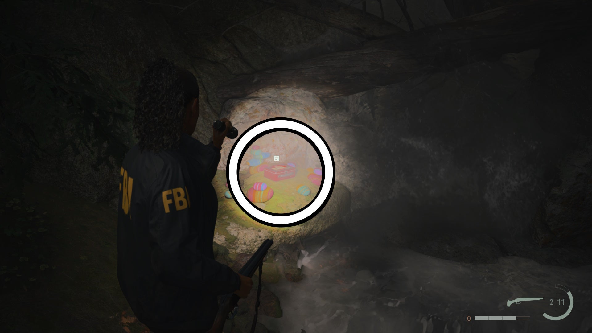 saga shining her flashlight on a lunch box sitting on top of a stone below a small waterfall