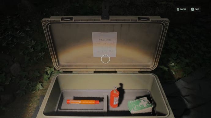 a light green container open with a note on the lid and a flare, propane tank, and first aid kit inside