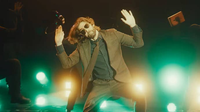 Alan Wake 2 screenshot from Herald of Darkness music section showing live action Alan dancing