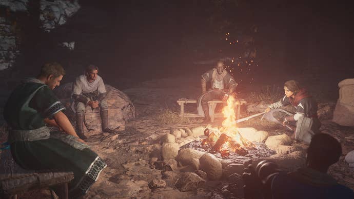 Basim and other Hidden Ones are gathered around a campfire in Assassin’s Creed: Mirage