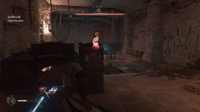 Basim hides behind a crate in Ali’s cell in the Damascus Gate Prison, where a guard taunts Ali in Assassin’s Creed Mirage