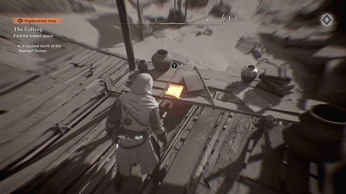 Basim faces a letter on a desk in the middle of the desert in Assassin’s Creed Mirage