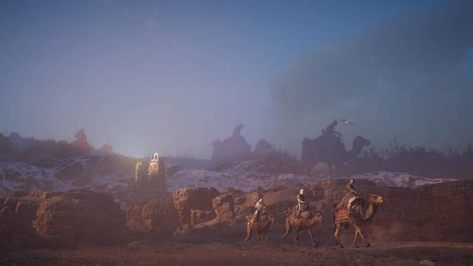 Multiple merchants travel on camels through a desert in Assassin’s Creed Mirage