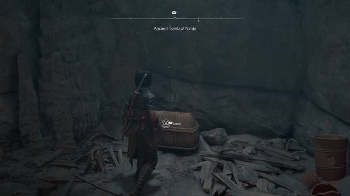 Naoe looking at a chest in a cave in Assassin’s Creed Shadows.