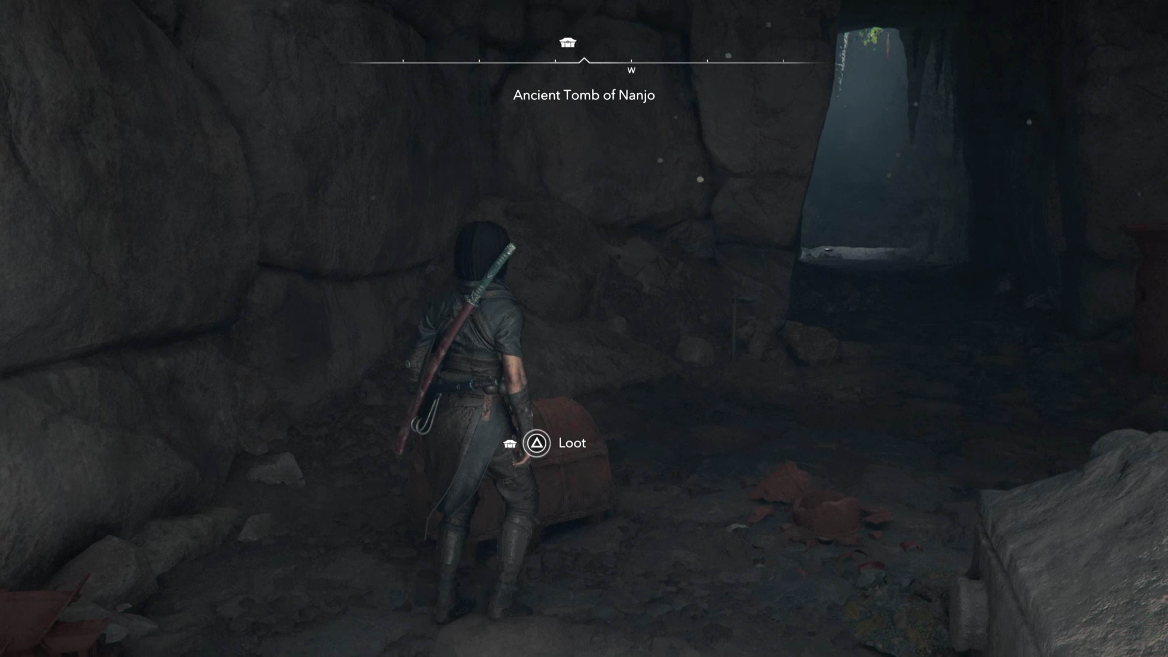 Naoe looking at a chest in a cave in Assassin&rsquo;s Creed Shadows.