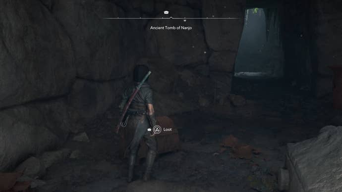 Naoe looking at a chest in a cave in Assassin’s Creed Shadows.