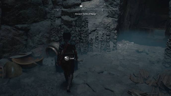 Naoe looking at a chest in a cave in Assassin’s Creed Shadows.