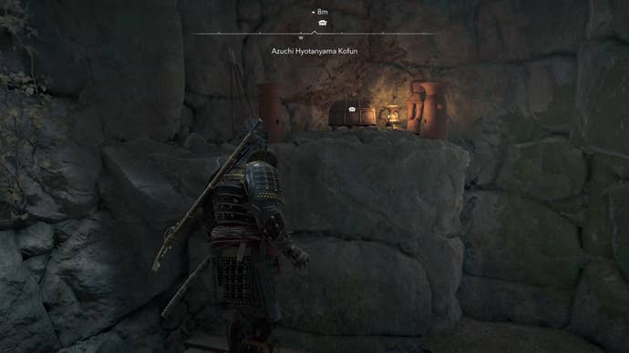 Yasuke looking at a chest across the way inside the Azuchi Kyotanyama Kofun in Assassin’s Creed Shadows.