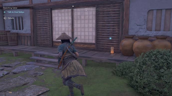 Naoe standing outside a house in Assassin’s Creed Shadows.