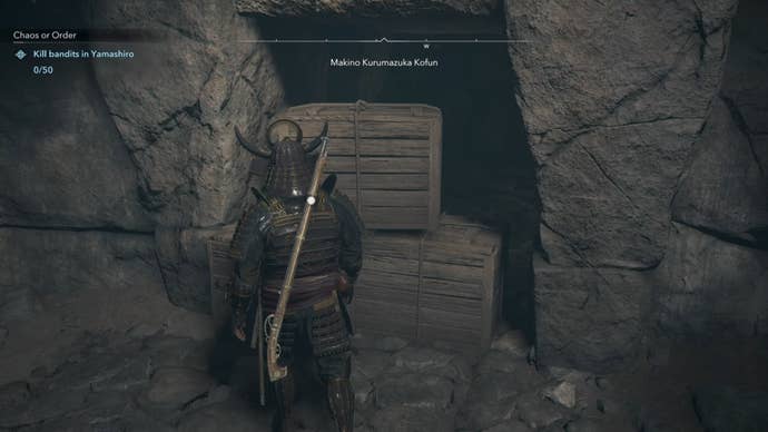 Yasuke looking at three wooden boxes in Assassin’s Creed Shadows.