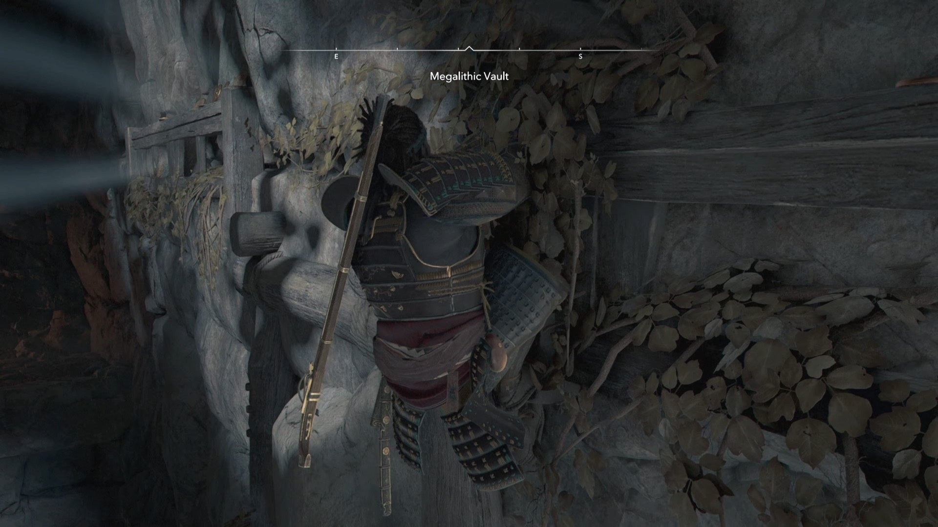Yasuke climbing a ledge inside the Megalithic Vault Kofun in Assassin&rsquo;s Creed Shadows.