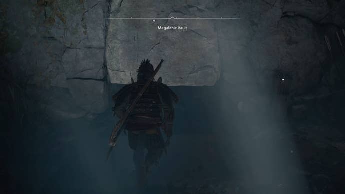 Yasuke beside a gap in the wall inside the Megalithic Vault Kofun in Assassin’s Creed Shadows.