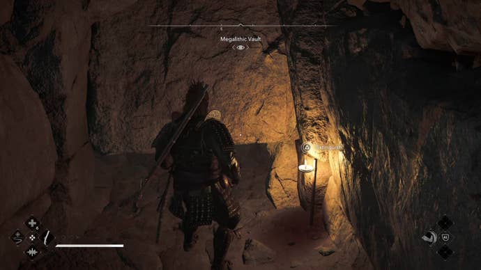 Yasuke looking at a gap in the wall inside the Megalithic Vault Kofun in Assassin’s Creed Shadows.