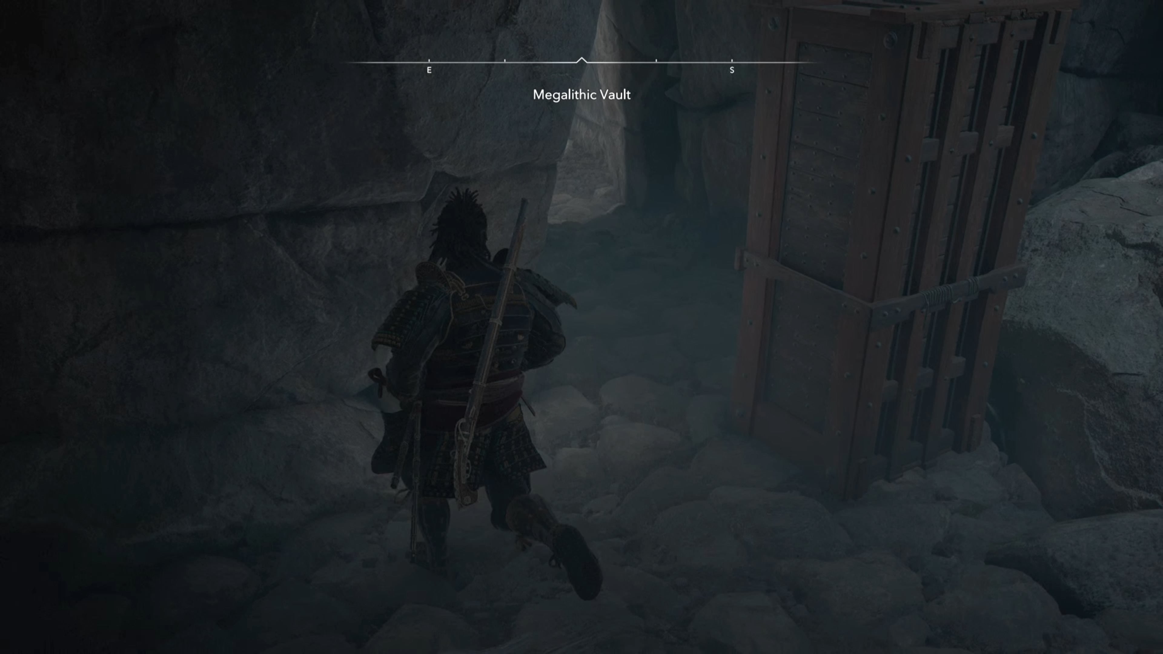 Yasuke beside a wooden block inside the Megalithic Vault Kofun in Assassin&rsquo;s Creed Shadows.
