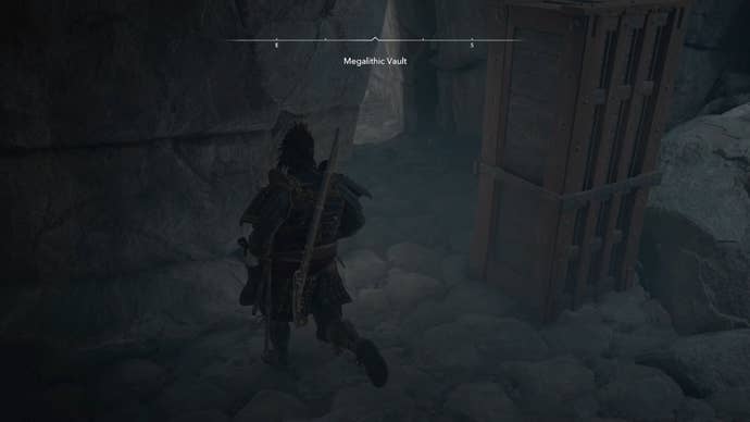 Yasuke beside a wooden block inside the Megalithic Vault Kofun in Assassin’s Creed Shadows.
