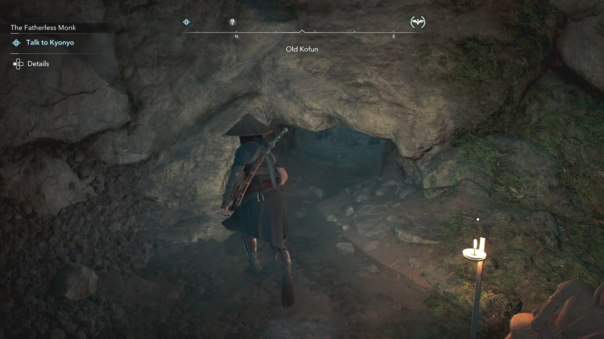 Naoe standing beside a gap in a wall inside the Old Kofun in Assassin&rsquo;s Creed Shadows.