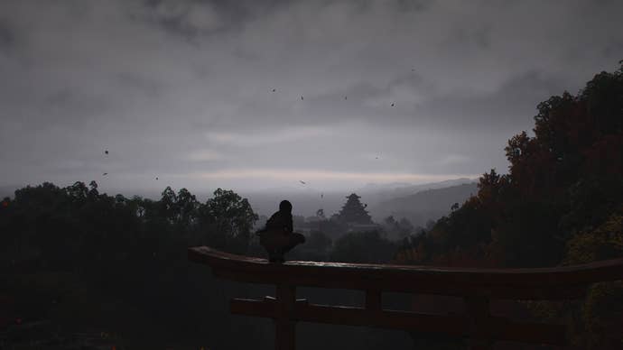 AC Shadows screenshot showing a perched Naoe looking out towards a distant Osaka castle through evening fog