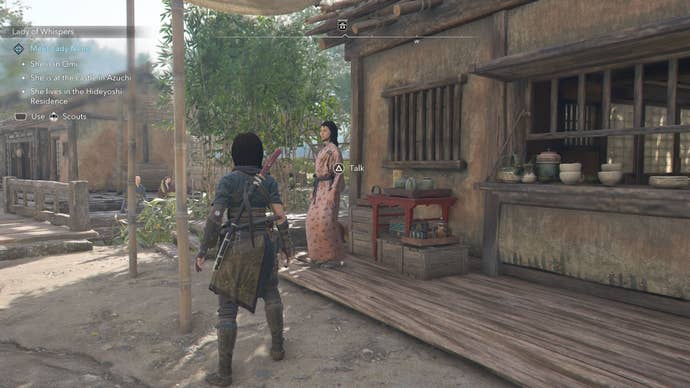 Naoe looking at an Ornament Vendor that sells a tea bowl in Assassin’s Creed Shadows.