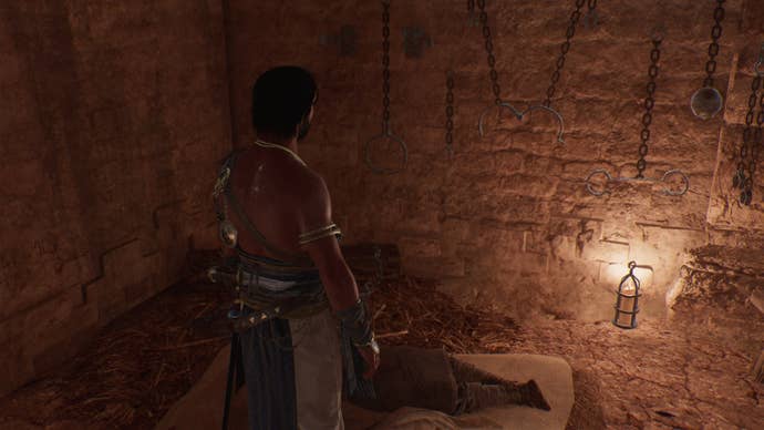 Basim stands beside a deceased prisoner with a disguise he can steal in Assassin's Creed Mirage