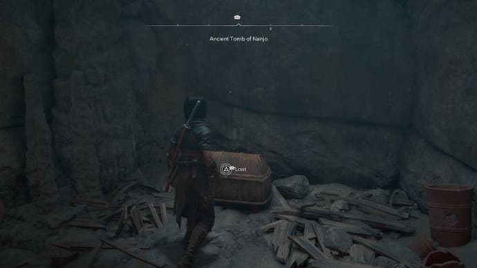 Naoe looking at a chest in a cave in Assassin's Creed Shadows.