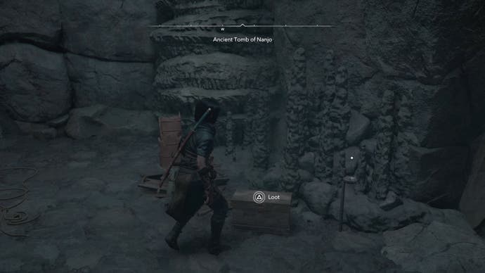 Naoe looking at a chest in a cave in Assassin's Creed Shadows.