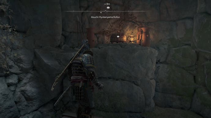 Yasuke looking at a chest opposite the interior of Azuchi Kyotanyama Kofun in Assassin's Creed Shadows.