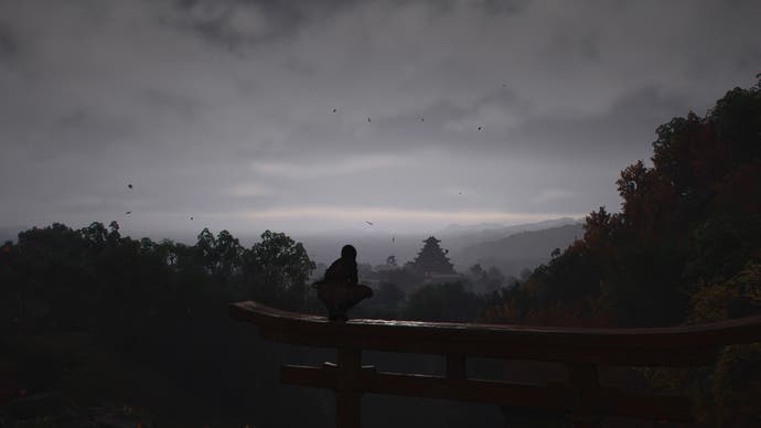 AC Shadows screenshot showing a perched Naoe looking out towards a distant Osaka castle through evening fog