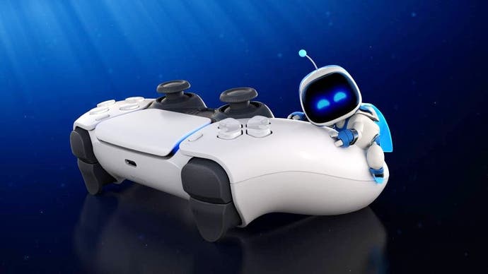 Astro Bot cuddles a PlayStation 5 controller.