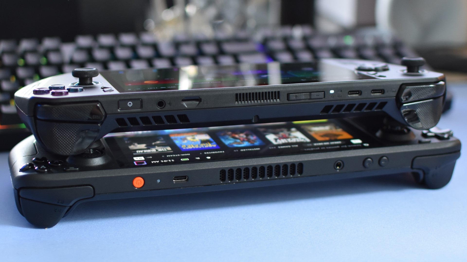 An Asus ROG Ally X connected  apical  of a Steam Deck OLED.