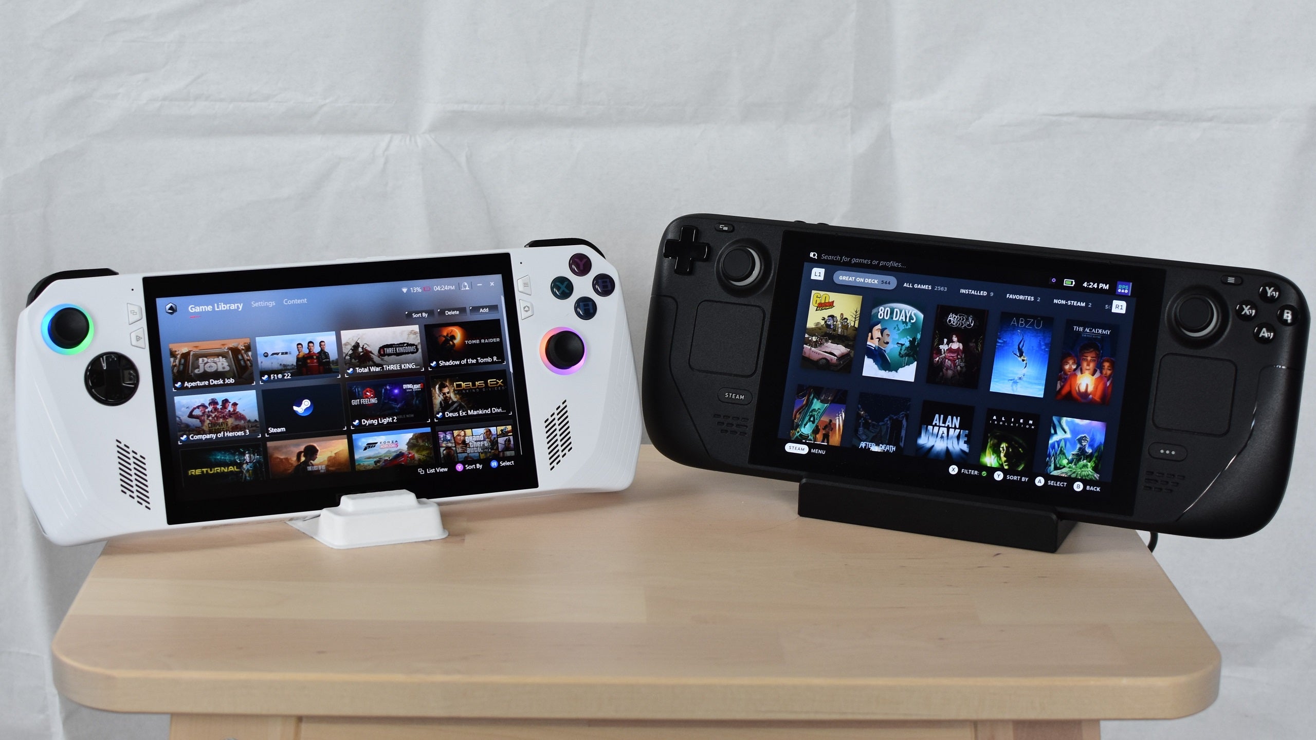 An Asus ROG Ally sat next to a Steam Deck on a small table.
