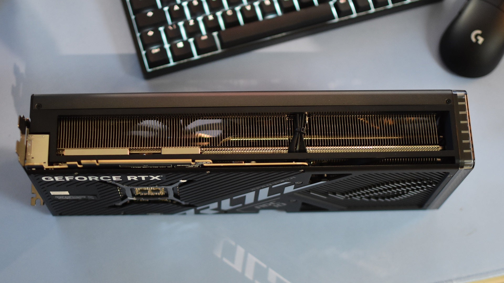 A Asus ROG Strix GeForce RTX 4080 Super Gaming OC Edition graphics card on its side. - 9