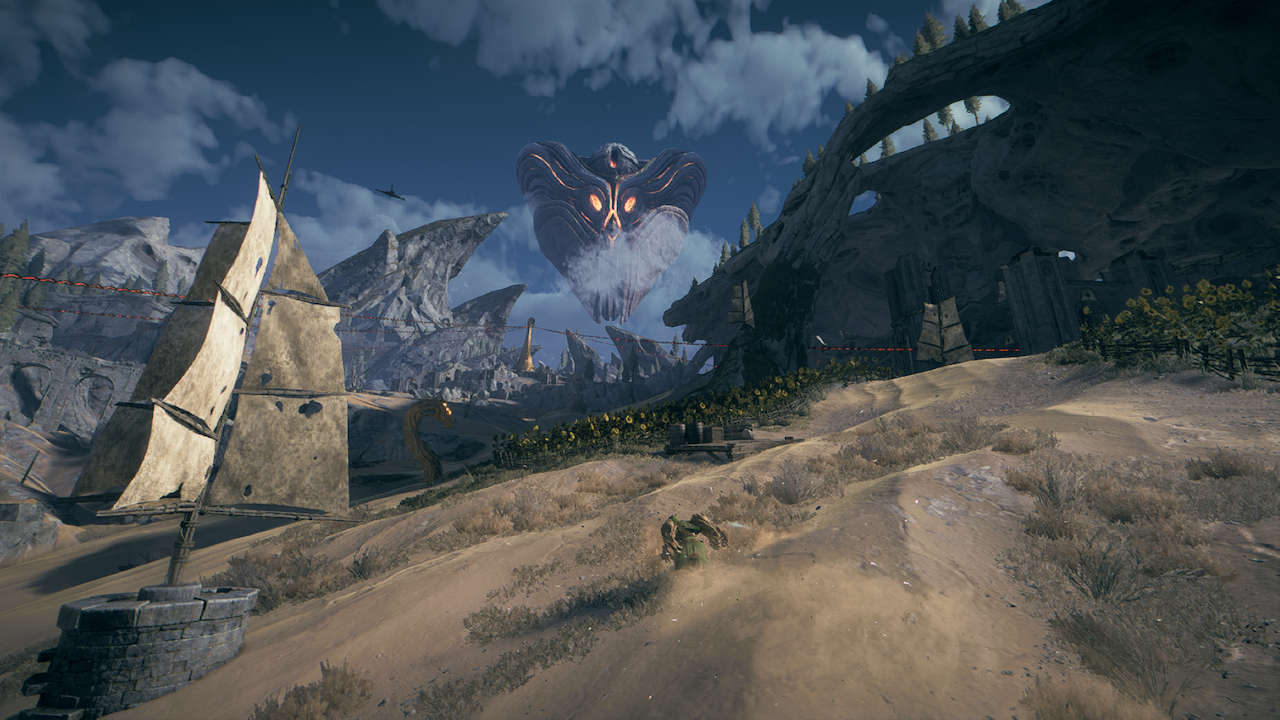 Screenshot from Atlas Fallen, showing the player character sliding through sand with an enemy worm in the background.